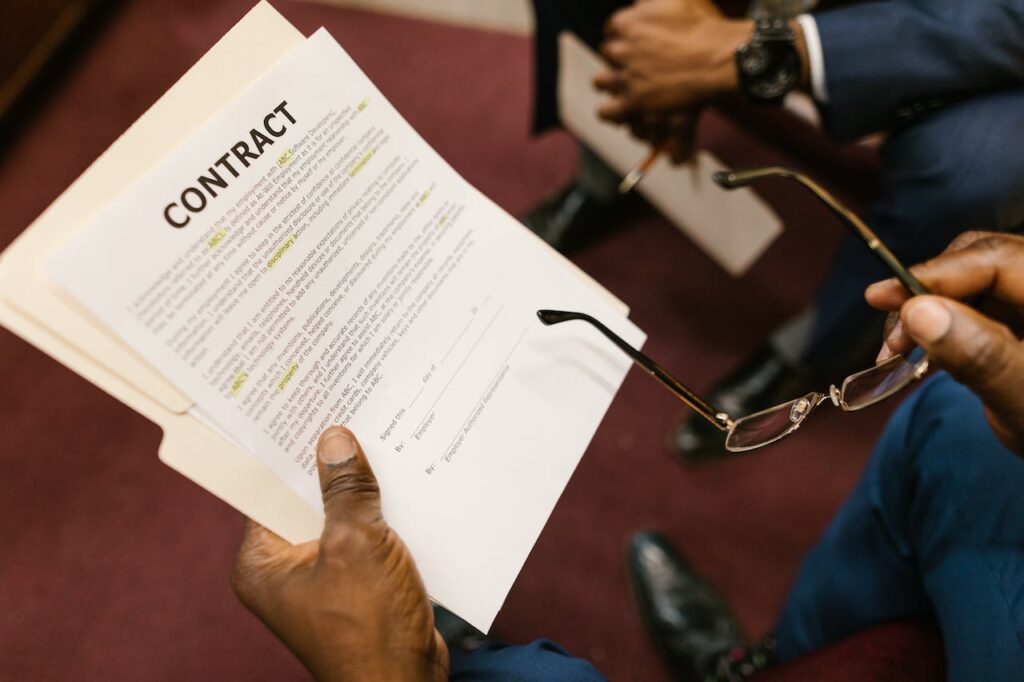 businessman who needs a lawyer for mediation looking over a contract